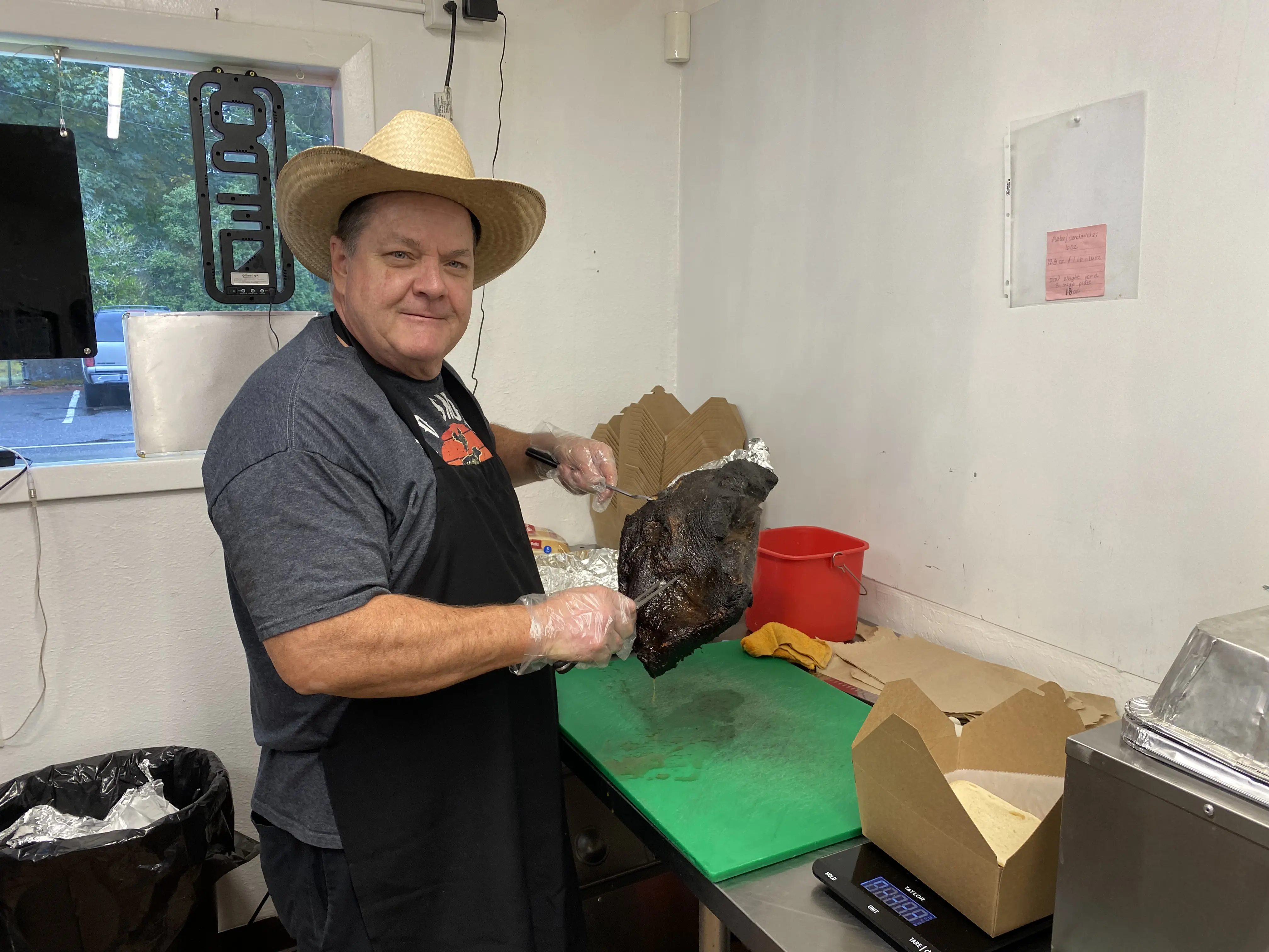 Chef Mark presenting smoked meats at Shorty's BBQ